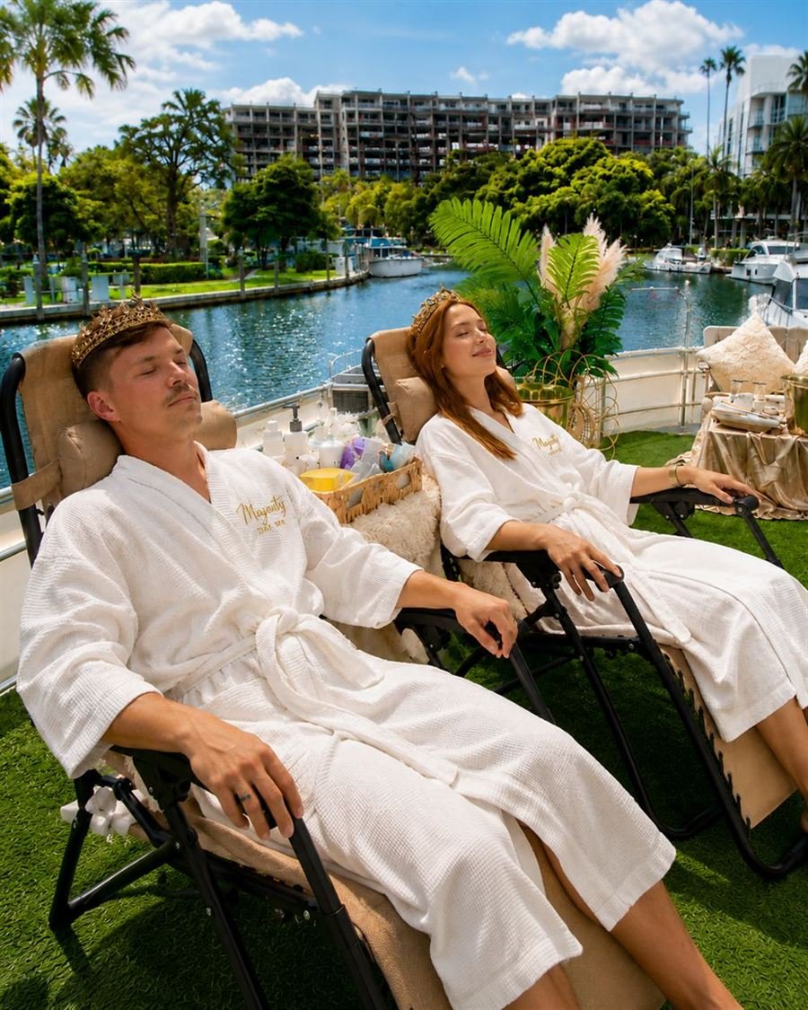 A couple relaxing side by side in Majesty Day Spa robes